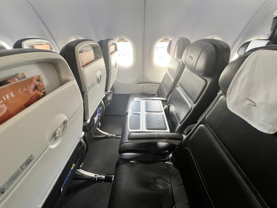 Empty business class seats in black leather on a British Airways Airbus A320.
