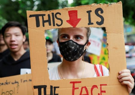 An environmental activist participates in a Global Climate Strike near the Ministry of Natural Resources and Environment office in Bangkok