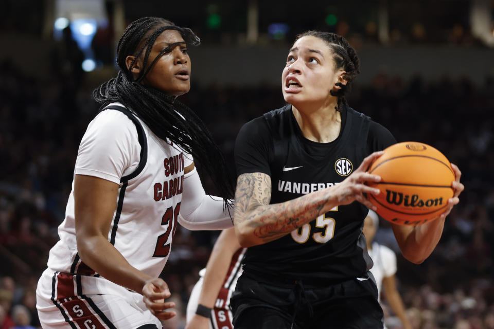 Vanderbilt forward Sacha Washington, right, looks to shoot over South Carolina forward Sania Feagin, left, during the second half of an NCAA college basketball game in Columbia, S.C., Sunday, Jan. 28, 2024. (AP Photo/Nell Redmond)