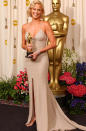 <p>In 2004, Charlize showed off her California tan in this slinky, gold Gucci gown. The actress looked stunning as she accepted her Best Actress award for her role as serial killer Aileen Wuornos in Monster.</p>