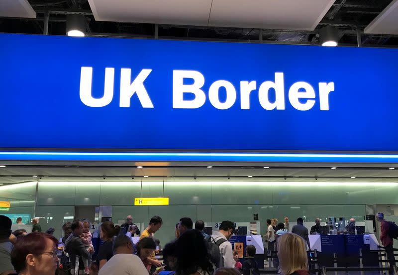 FILE PHOTO: Signage is seen at the UK border control point at the arrivals area of Heathrow Airport, London