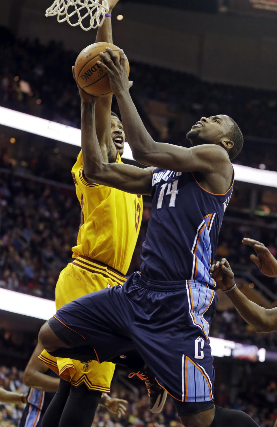Charlotte Bobcats' Michael Kidd-Gilchrist (14) goes up to shoot against Cleveland Cavaliers' Tristan Thompson in the first quarter of an NBA basketball game on Saturday, April 5, 2014, in Cleveland. (AP Photo/Mark Duncan)