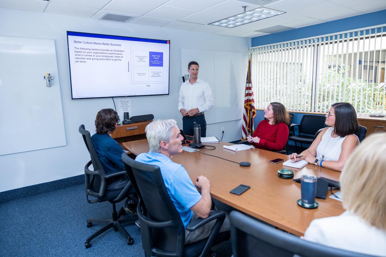 Chad Seelig, Rite-Solutions chief financial officer, leads an employee meeting.