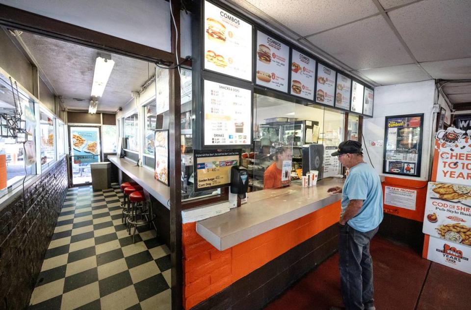 Mike Woodward orders food at A&W drive-in restaurant in Modesto, Calif., Tuesday, July 25, 2023.