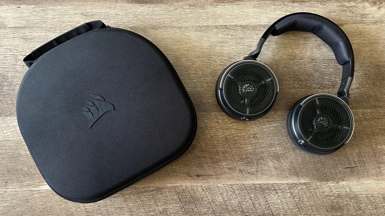  Corsair Virtuoso Pro headset and case on a wooden table. 