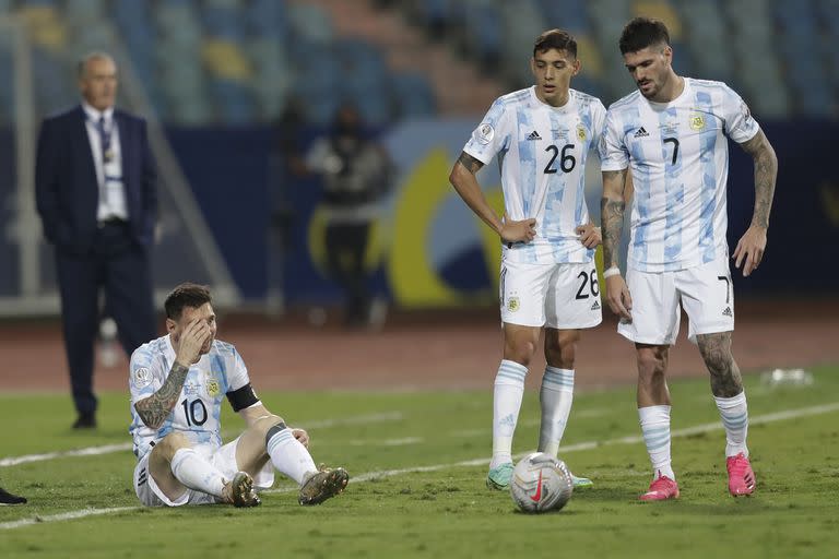 Messi, sentado, mientras Molina y De Paul conversan. Detrás, Alfaro.