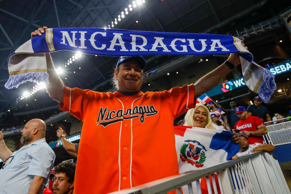 Mar 13, 2023; Miami, Florida, USA; A baseball fan of Nicaragua enjoys the game against Dominican Republic during the first round of the World Baseball Classic at LoanDepot Park. Mandatory Credit: Sam Navarro-USA TODAY Sports