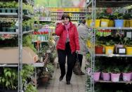 A customer speaks on the phone as she visits the gardening department at a store of the OBI retailer in the suburbs of Moscow, Russia, April 6, 2016. REUTERS/Maxim Shemetov