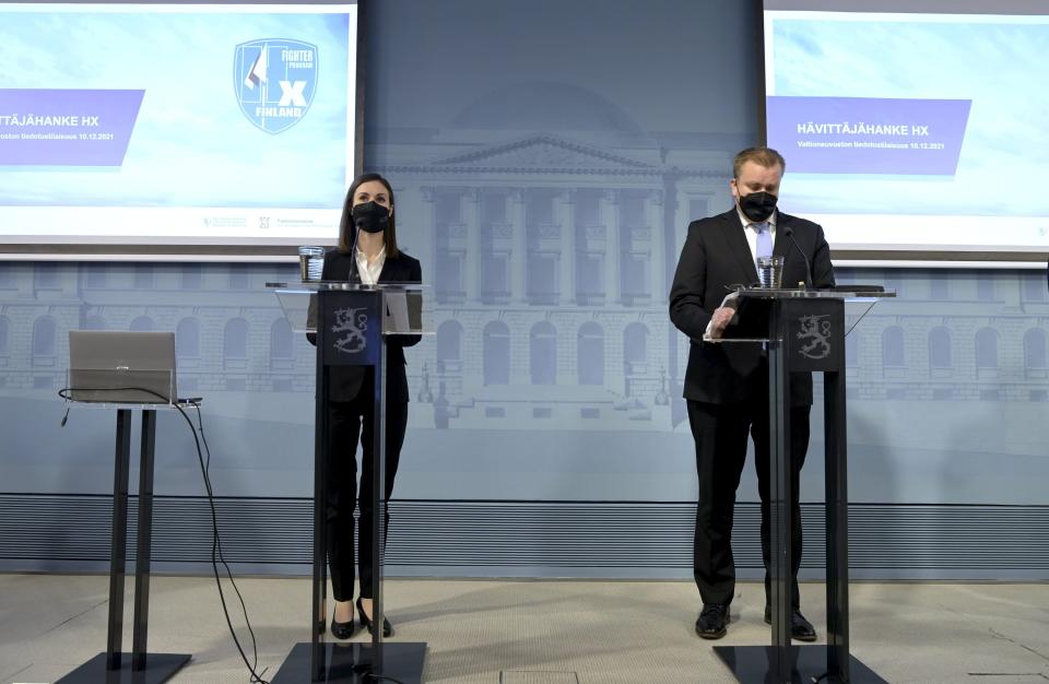 Finland's Prime Minister Sanna Marin, left and Minister of Defense Antti Kaikkonen take part in a press conference, in Helsinki, Finland, Friday, Dec. 10, 2021. (Vesa Moilanen/ Lehtikuva via AP)