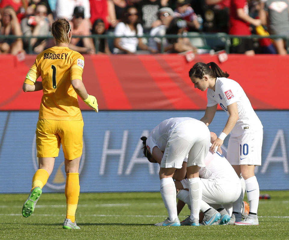 Laura Bassett is consoled by team-mates after scoring a heart-breaking own-goal against Japan