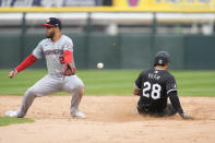 Chicago White Sox's Tommy Pham, right, slides safely to second base by Washington Nationals second baseman Luis García Jr. and then on to third on a throwing error by catcher Riley Adams during the fifth inning in the first baseball game of a doubleheader, Tuesday, May 14, 2024, in Chicago. (AP Photo/Erin Hooley)