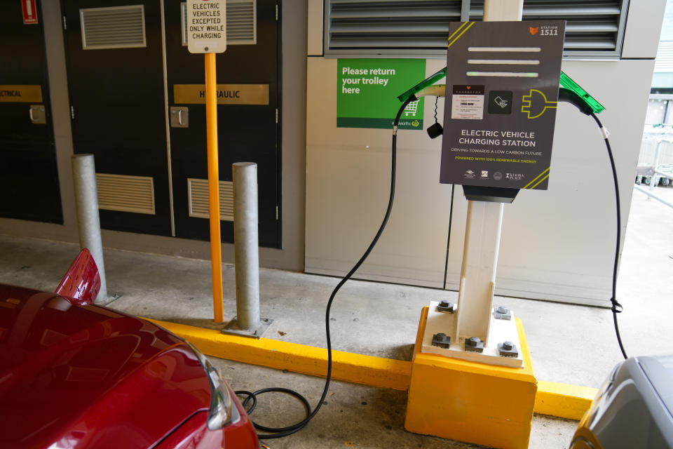 Electric cars get charged at a supermarket carpark in Sydney, Australia, Tuesday, Nov. 9, 2021. Australia's Prime Minister Scott Morrison has announced plans to encourage people to buy electric vehicles with a 250 million Australian dollar ($185 million) plan that partners with private enterprise to accelerate the rollout of 50,000 charging and hydrogen refueling stations across the nation. (AP Photo/Mark Baker)