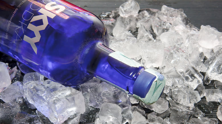 A blue bottle of Skyy vodka over ice