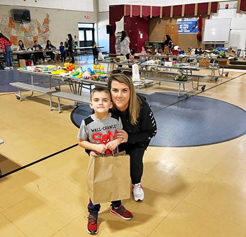 Gonic School Kindergartener Cohen Strydom stands with his mom, Parent Teacher Association Volunteer Stephanie Strydom during the shopping spree.