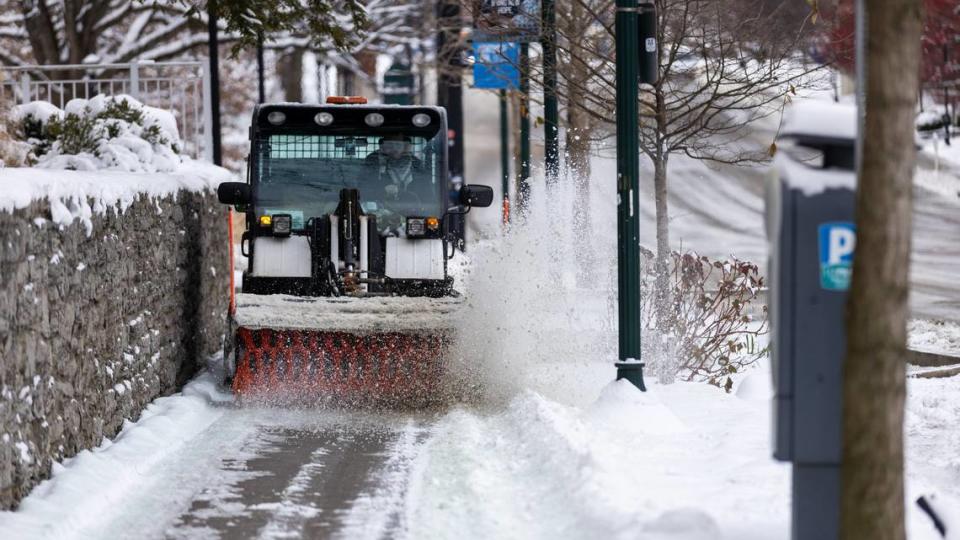 A plow cleared snow off of sidewalks next to University of Kentucky dorms along South Limestone move-In day Friday morning, Jan. 7, 2022.