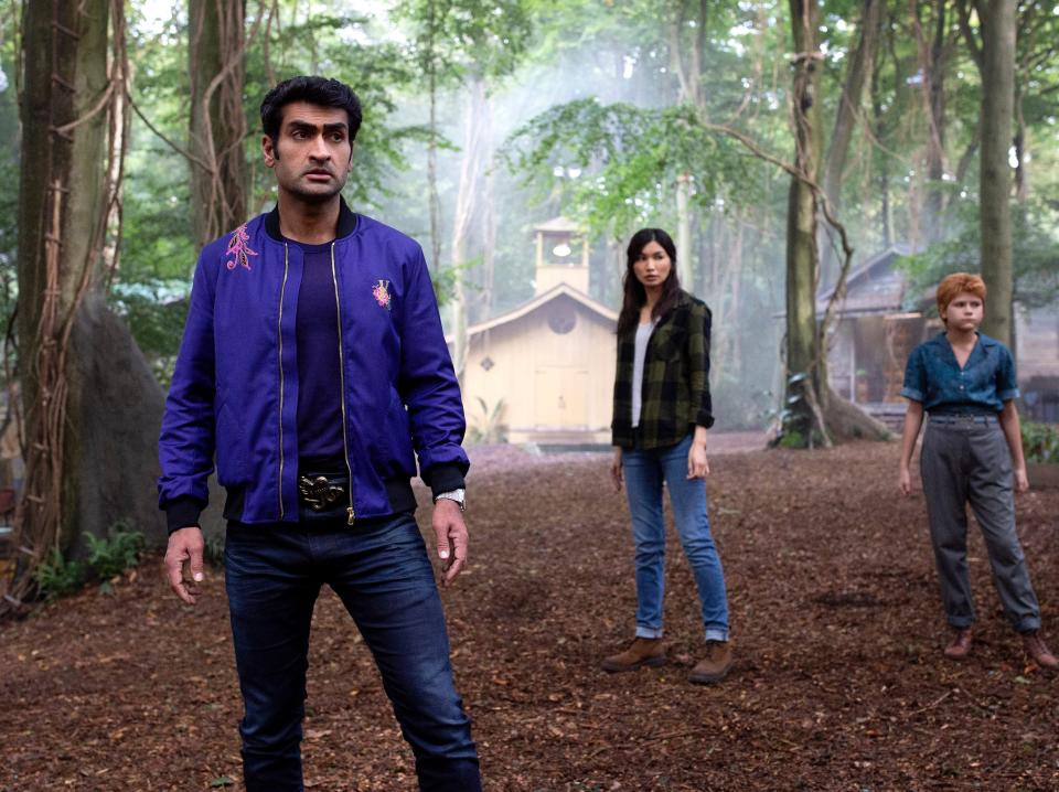 Kumail Nanjiani, Gemma Chan, and Lia McHugh standing in the woods in "Eternals."