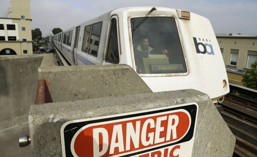 A Bay Area Rapid Transit train approaches the Fruitvale station Saturday, Oct. 12, 2013, in Oakland, Calif. A major San Francisco Bay Area transit system ran trains as usual on Saturday after labor negotiations were extended past a midnight deadline, but the threat of a commute-disrupting strike loomed with the unions promising to walk off the job Monday if weekend talks fail to reach a deal. (AP Photo/Ben Margot)