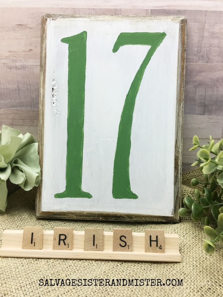 plaque hand painted white with the number 17 in green there are scrabble tiles spelling out irish below