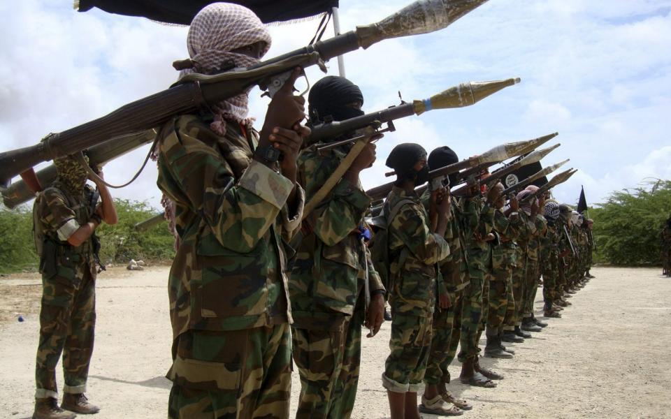 Al Shabaab recruits conduct a military parade at a training camp south of the Somali capital Mogadishu - FEISAL OMAR/Reuters