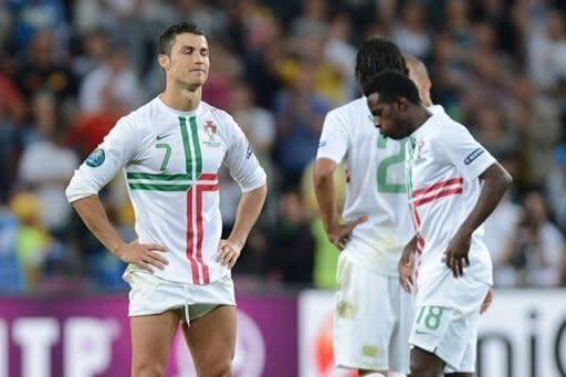 Portuguese forward Cristiano Ronaldo and Portuguese forward Silvestre Varela look dejected at the end of the Euro 2012 football championships semi-final match Portugal vs Spain at the Donbass Arena in Donetsk. Spain won 4-2 on penalties