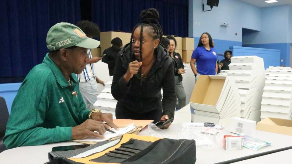 Ray Bellamy and Cici Alvarez quarterback the distribution of boxes of Thanksgiving food Tuesday, 11/21/2023, at Lincoln Memorial Middle School.