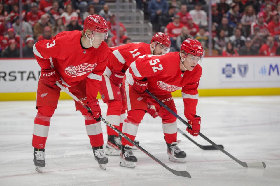 Detroit Red Wings defenseman Simon Edvinsson (3) and right wing Jonatan Berggren (52) look on before at faceoff in the first period vs. the Colorado Avalanche at Little Caesars Arena, March 18, 2023.