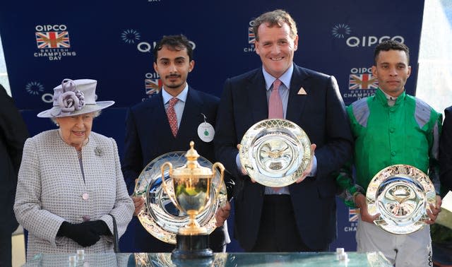 Queen Elizabeth II alongside winning Jockey Sean Levey during Champions Day at the Royal Ascot Racecourse in 2019 