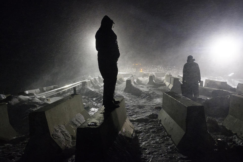 A protester stands on a concrete barricade at the "Blackwater Bridge" law enforcement blockade.