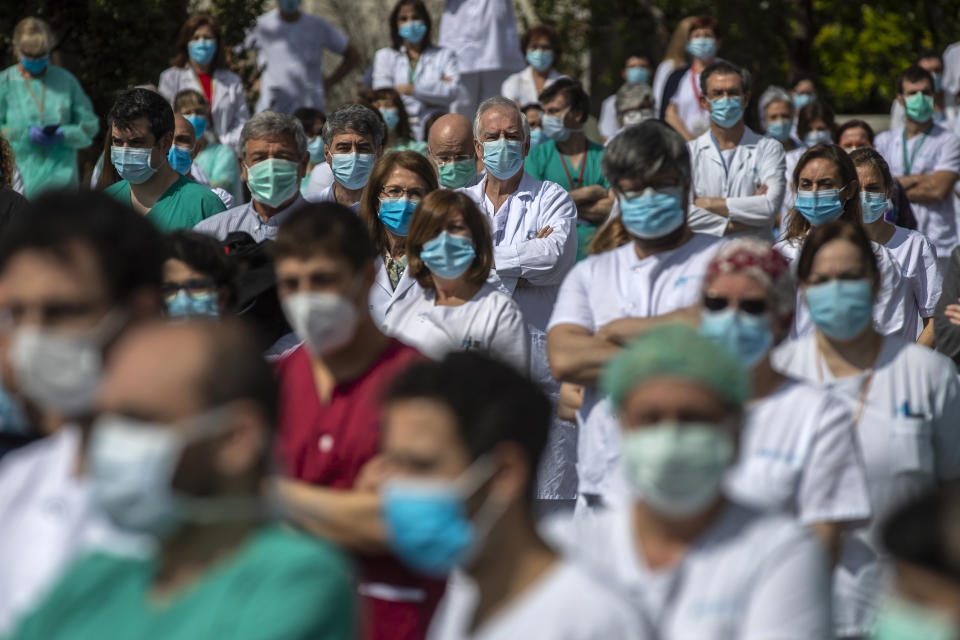Health workers hold a minute of silence in Madrid, Spain, Monday, April 20, 2020. (AP Photo/Manu Fernandez)