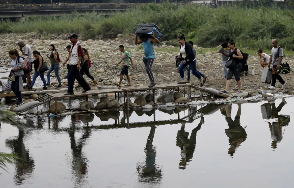 FILE - Venezuelans cross illegally into Colombia.