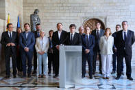 Catalan Regional President Carles Puigdemont is flanked by members of his government as he makes an statement at Generalitat Palace during a raid on several government offices in Barcelona, Spain, September 20, 2017. Catalan Goverment/Ruben Moreno Garcia/Handout via REUTERS