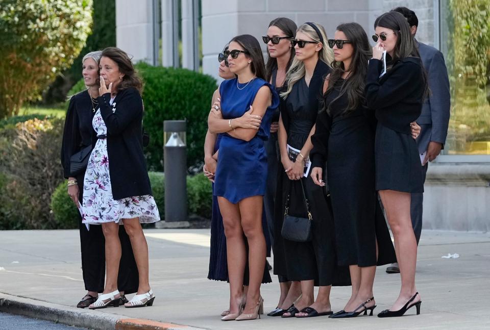 Jane Gaudreau, second from left, and Meredith Gaudreau, middle in blue, watch with friends and family as a hearse carries away the casket Johnny Gaudreau following his funeral at St. Mary Magdalen Parish. Johnny and Matthew Gaudreau died after being hit by an alleged drunk driver while riding bicycles on Aug. 29.