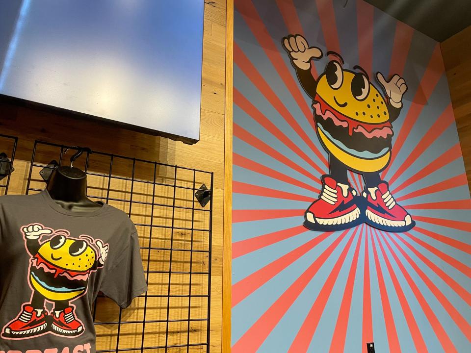 The MrBeast Burger logo on the wall and a tshirt