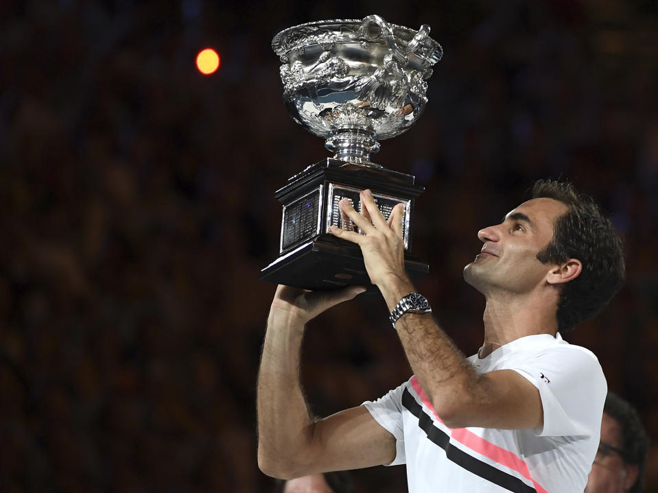 Roger Federer holds his trophy after defeating Marin Cilic during the final at the Australian Open in Melbourne, Australia, Sunday, Jan. 28, 2018. (AP Photo/Andy Brownbill)