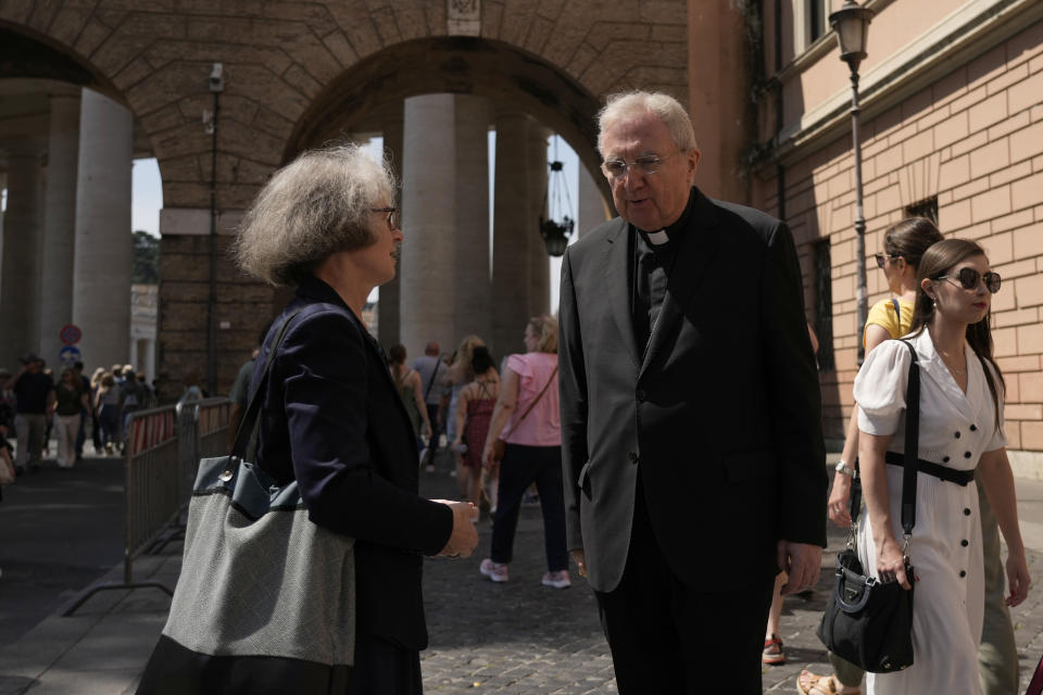 Sister Nathalie Becquart, the first female undersecretary in the Vatican's Synod of Bishops, shares a word with Cardinal Arthur Roche on her way to the Vatican, Monday, May 29, 2023. Becquart is charting the global church through an unprecedented, and even stormy, period of reform as one of the highest-ranking women at the Vatican. (AP Photo/Alessandra Tarantino)