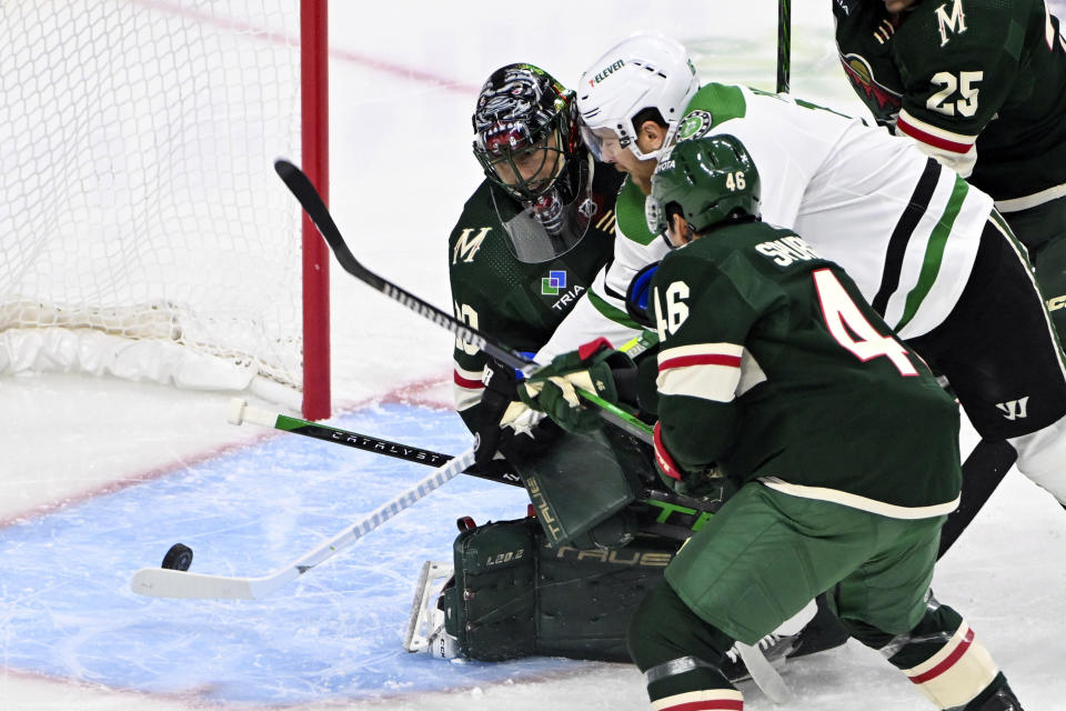 Dallas Stars center Joe Pavelski, center, scores a goal past Minnesota Wild goalie Marc-Andre Fleury, left, and defenseman Jared Spurgeon during the first period of an NHL hockey game, Sunday, Nov. 12, 2023, in St. Paul, Minn. (AP Photo/Craig Lassig)