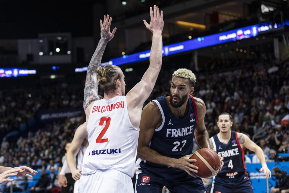 BERLIN, GERMANY – SEPTEMBER 16: <a class="link " href="https://sports.yahoo.com/nba/players/5197" data-i13n="sec:content-canvas;subsec:anchor_text;elm:context_link" data-ylk="slk:Rudy Gobert;sec:content-canvas;subsec:anchor_text;elm:context_link;itc:0">Rudy Gobert</a> of France dribbles the ball next to Aleksander Roman Olek Balcerowski of Poland during the FIBA EuroBasket 2022 semi-final match between Poland and France at EuroBasket Arena Berlin on September 16, 2022 in Berlin, Germany. (Photo by Maja Hitij/Getty Images)