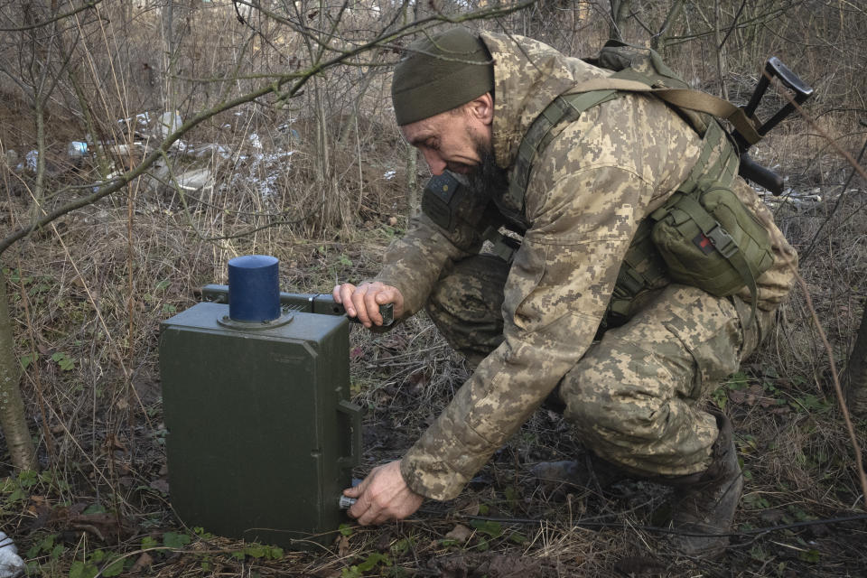 A Ukrainian soldier installs an electronic warfare system to quell Russian drones at the front line, near Bakhmut, Donetsk region, Ukraine, Monday, Jan. 29, 2024. Ukrainian forces are increasingly resorting to an age-old tactic — intelligence gleaned from radio intercepts — in a desperate effort to preserve their most vital resources. The painstaking work of eavesdropping is part of a larger effort to beef up and refine electronic warfare capabilities so that soldiers can be warned earlier of impending attacks, while having the battlefield intelligence needed to make their own strikes more deadly. (AP Photo/Efrem Lukatsky)