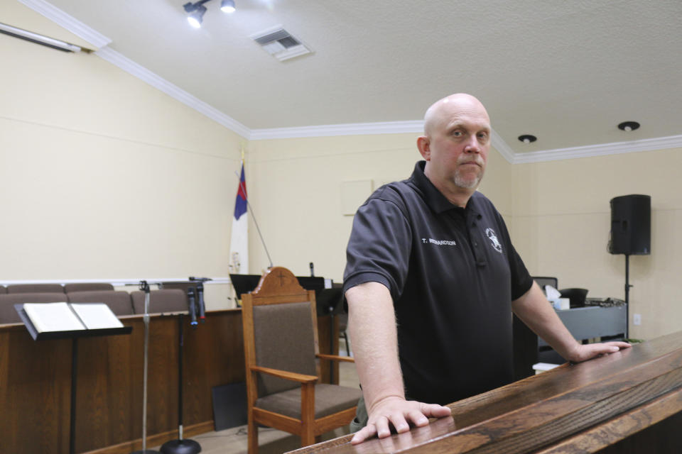 In this Oct. 17, 2019 photo, the Rev. Tommy Richardson, who serves as the chaplain for the sheriff's department, poses in Baker County, Fla. Richardson says his community is a forgiving place. Some Baker County residents express compassion for a teenager who wrote a school shooting plan and says he is in need of help. They are showing less mercy for a judge who released him without requiring mental health services, saying she failed their community and the boy she spared. (AP Photo/Bobby Caina Calvan)