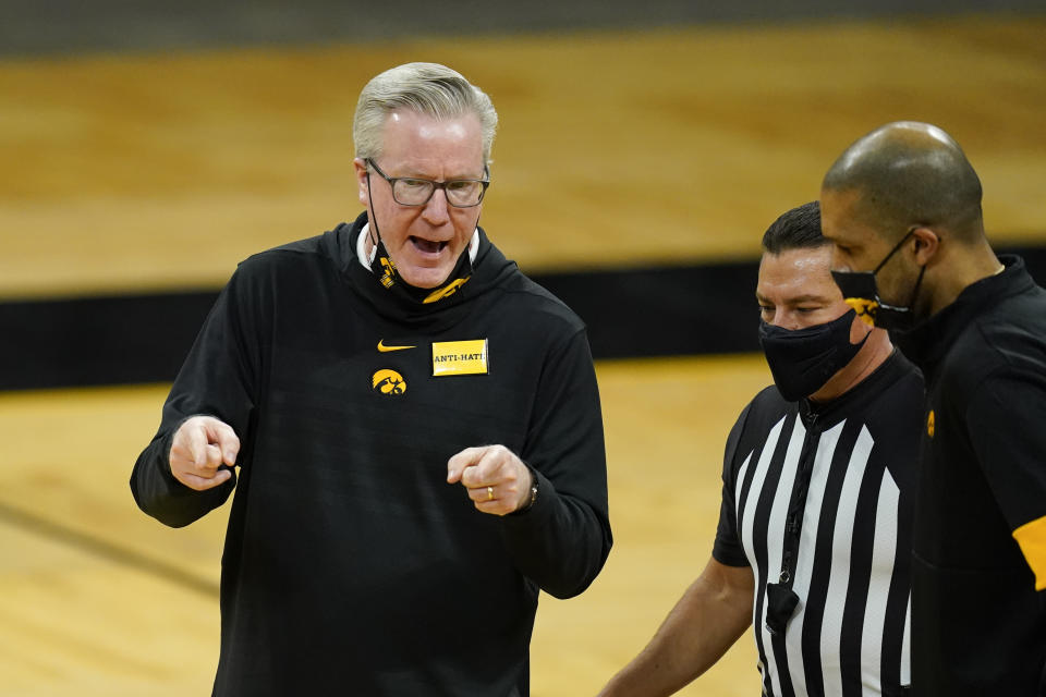 Iowa head coach Fran McCaffery, left, questions a call against his team during the second half of an NCAA college basketball game against Western Illinois, Thursday, Dec. 3, 2020, in Iowa City, Iowa. (AP Photo/Charlie Neibergall)