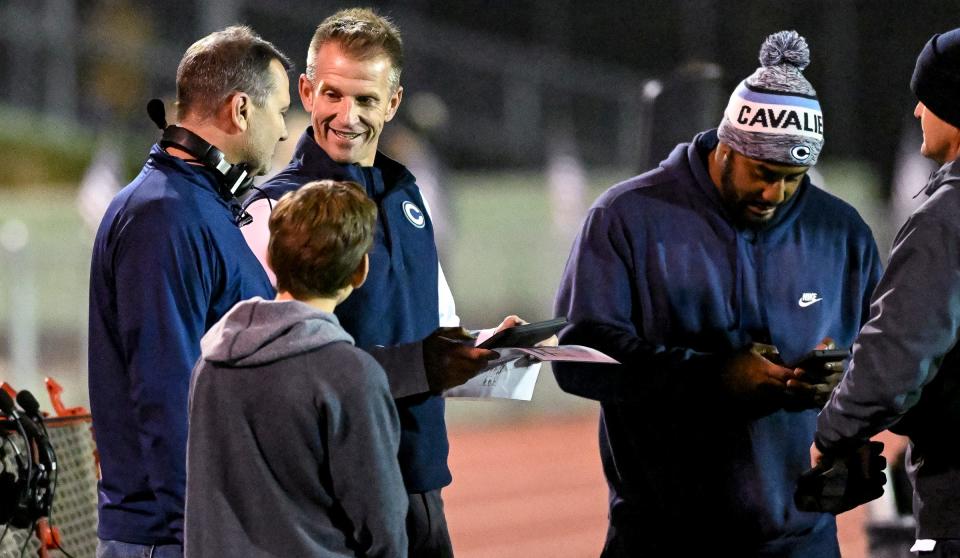 Central Valley Christian head coach Mason Hughes smiles on the sidelines against Sanger in a Central Section Division II high school quarterfinal football playoff Thursday, November 10, 2022.