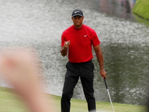 Woods makes a crucial birdie at the 16th (EPA)