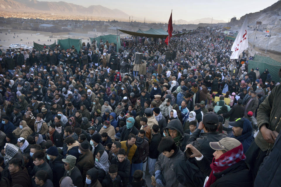 People from the Shiite Hazara community hold a sit-in to protest the killing of coal mine workers by gunmen near the Machh coal field, in Quetta, Pakistan, Wednesday, Jan. 6, 2021. Pakistan's minority Shiites continued their sit-in for a fourth straight day on the outskirts of the southwestern city of Quetta to protest the killing Sunday of 11 coal miners by the Islamic State group, insisting they will bury their dead only when Prime Minister Imran Khan personally visits them to assure protection. (AP Photo/Arshad Butt)