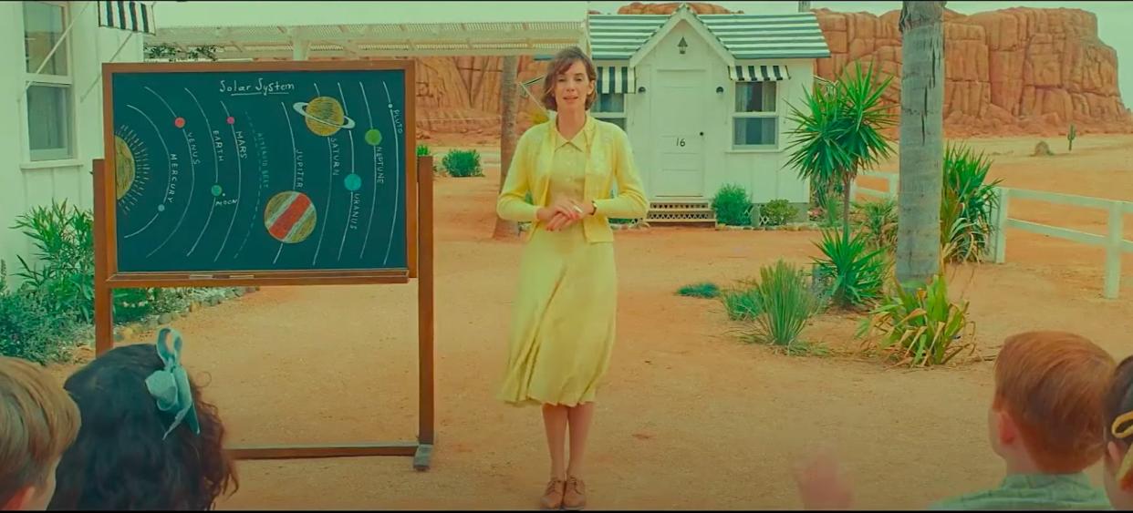  A still from "Asteroid City" showing Maya Hawke teaching a group of children about the solar system. 