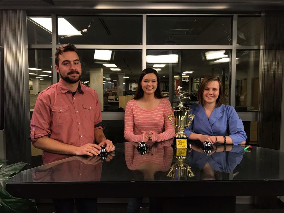 Jeopardy! Teen Tournament winner Claire Sattler, middle, stands with Naples Daily News reporters Andrew Atkins and Janie Haseman during a newsroom Jeopardy! tournament. Claire won the bout against the two journalists.