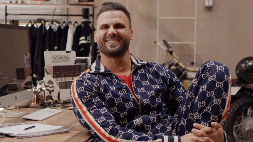 Jeremy Jackson laughs mischievously as he sits at a desk during his interview for After Baywatch: Moment in the Sun.