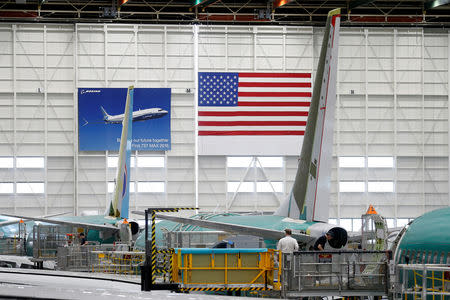 FILE PHOTO: Employees work on 737 Max aircraft, seen at the Boeing factory in Renton, Washington, U.S., March 27, 2019. REUTERS/Lindsey Wasson/File Photo