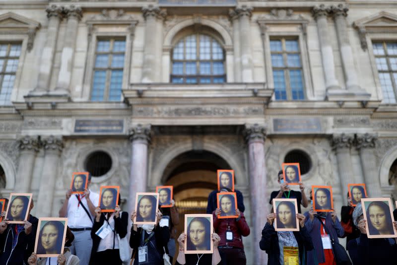 Paris tour guides gather at Le Louvre museum in Paris