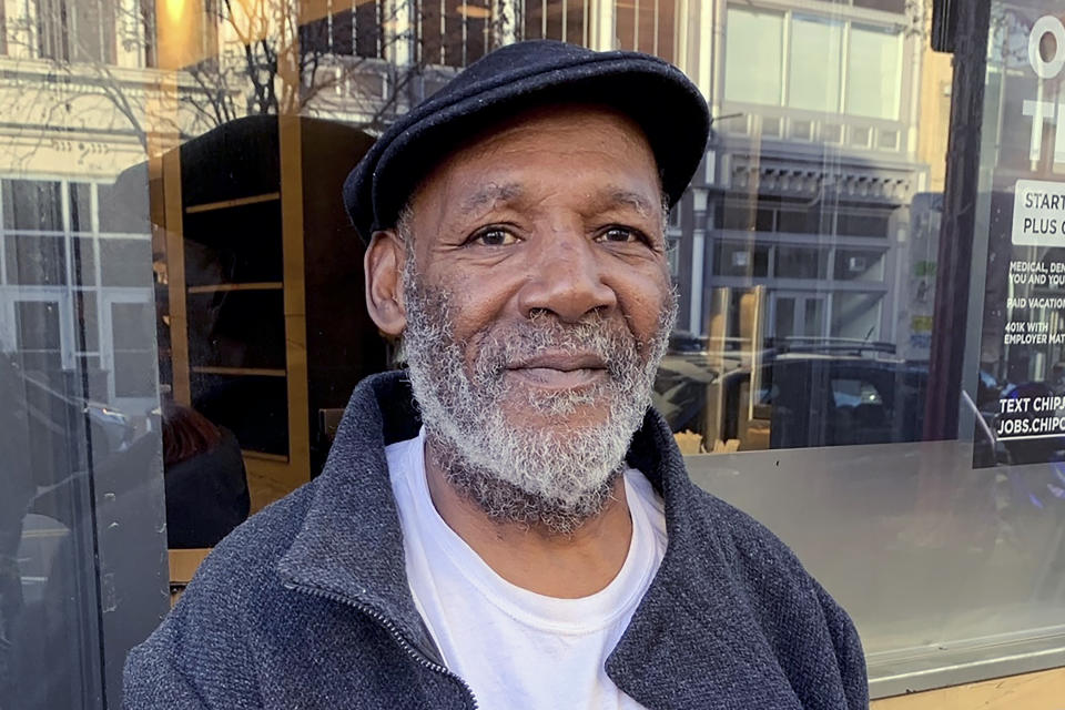 Sylvester Harris, a 54-year-old Washington native who panhandles near Capital One Arena, poses for a photo on Thursday, Dec. 7, 2023, in Washington. (AP Photo/Ashraf Khalil)