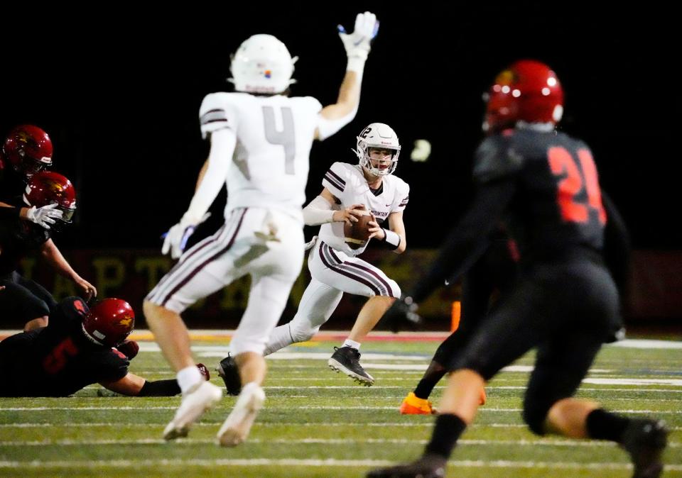 Desert Mountain Wolves quarterback Brady Mcdonough (12) looks to pass against the Chaparral Firebirds during a game played at Chaparral High in Scottsdale on Sept. 23, 2022.